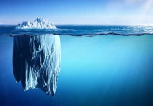 Picture shows an iceberg with a small part above and a great part under the sea level.